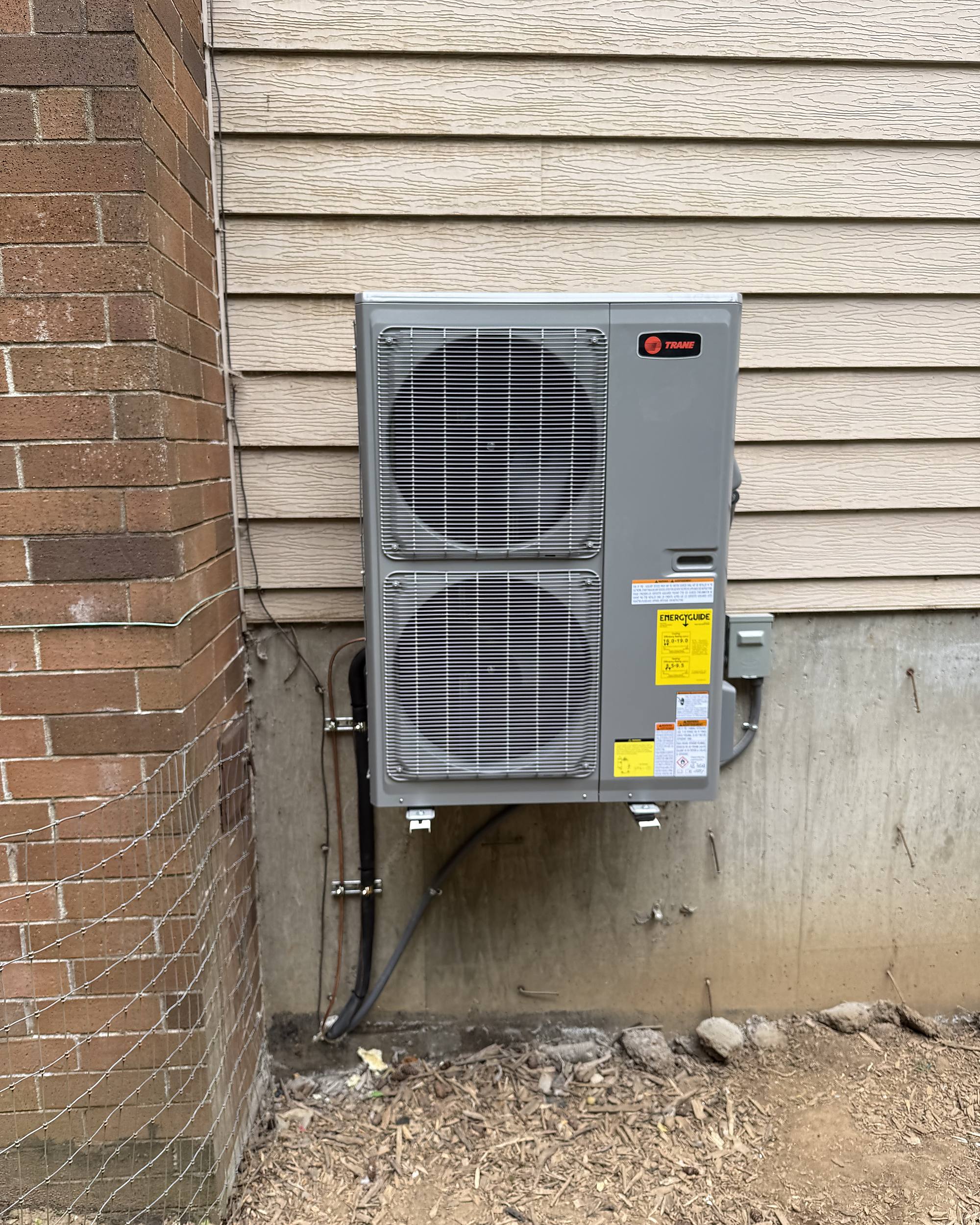 After: new outdoor unit wall-mounted off the ground